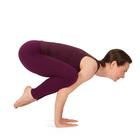 Frau demonstriert Yoga-Stellung Krähe